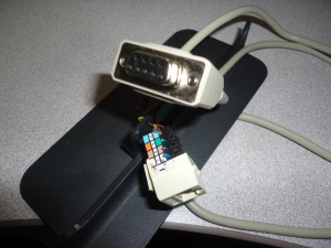 DB9 to RJ45 hacked cable. Ideally should be DB9 to RJ12. 